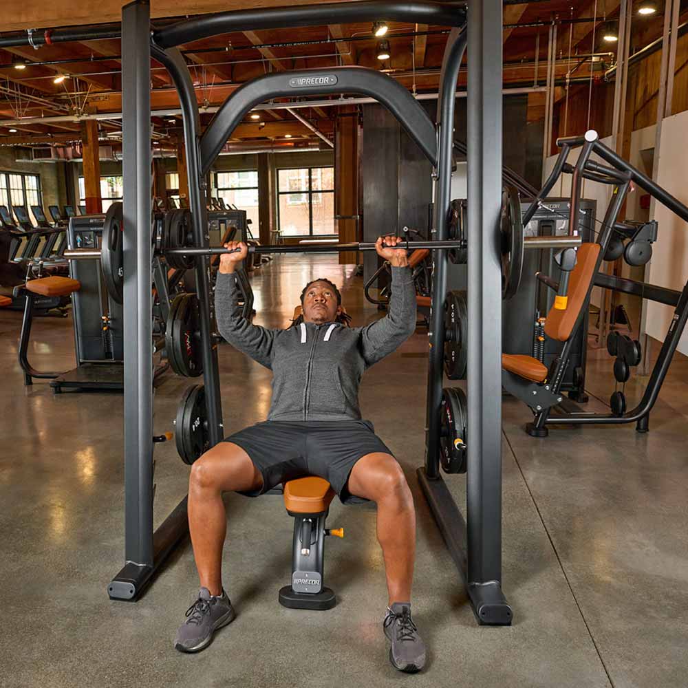 User performing an incline press on the Precor DPL-802 Smith Machine