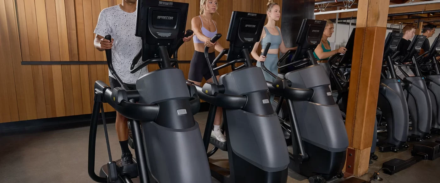 Precor AMT 800s lined up in a beautiful wood trimmed gym space