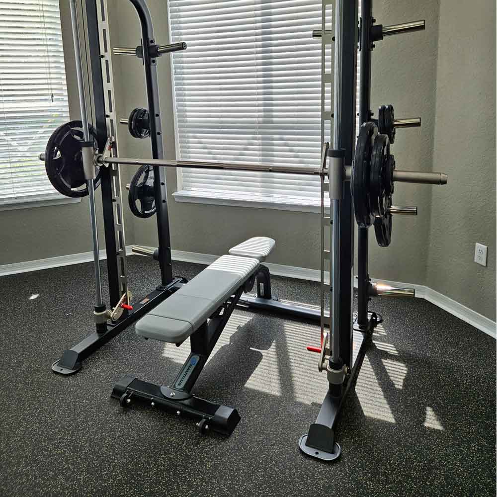 Nautilus Instinct multi-adjustable bench positioned with a Smith machine in the Andover Place apartment fitness center in Tampa, Florida